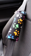 Black and multi-coloured paw print fleece car seatbelt pads 1 pair