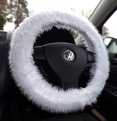 Car steering wheel with a white fuzzy cover inside a vehicle